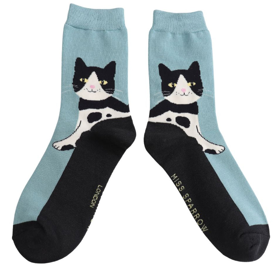 A pair of duck egg blue socks. With a Tuxedo Cat design. 