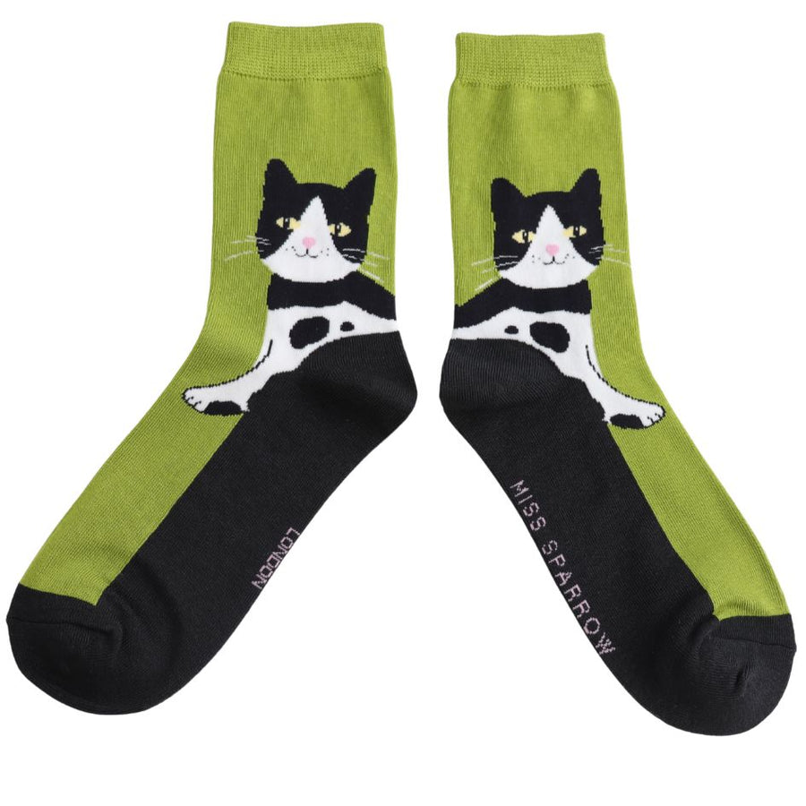 A pair of Tuxedo Cat Socks. A green and black sock with tuxedo cat design. 