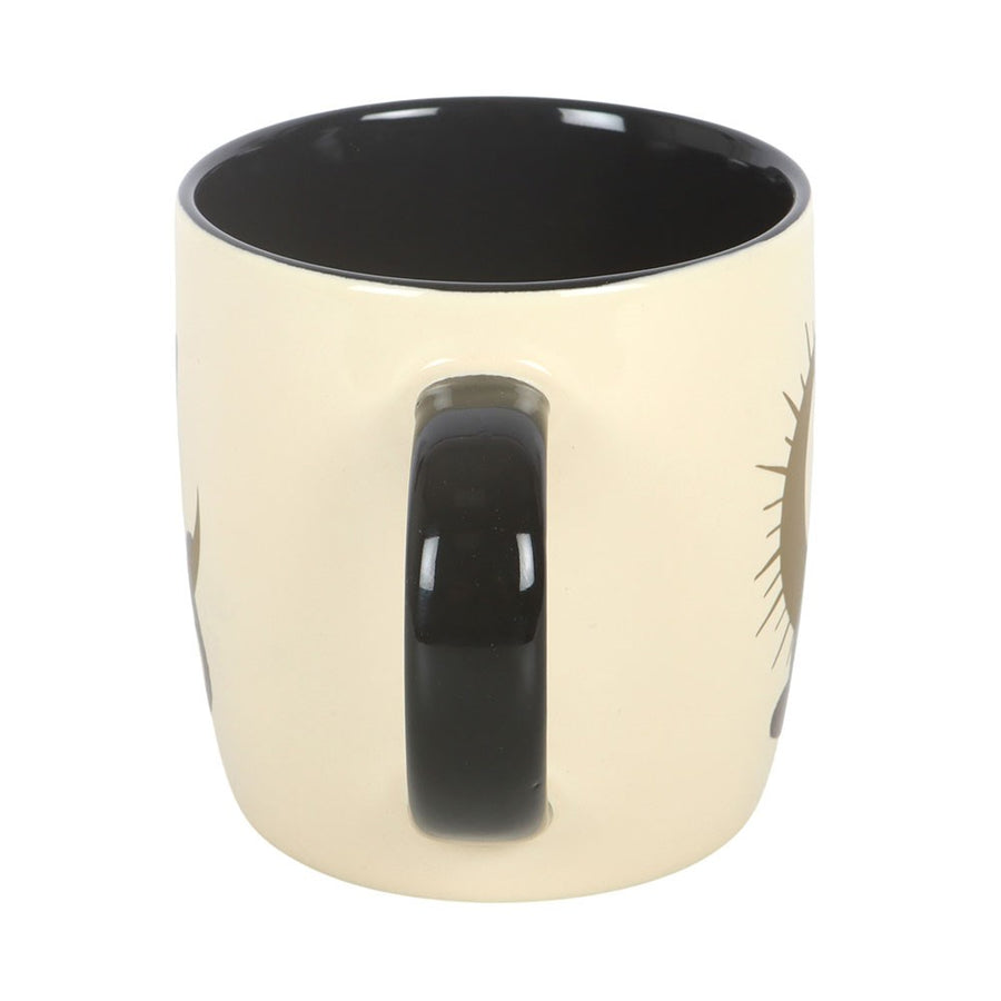 Beige mug with black interior and handle on a white background