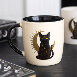 White mug with black interior, featuring a black cat design on a dark surface.