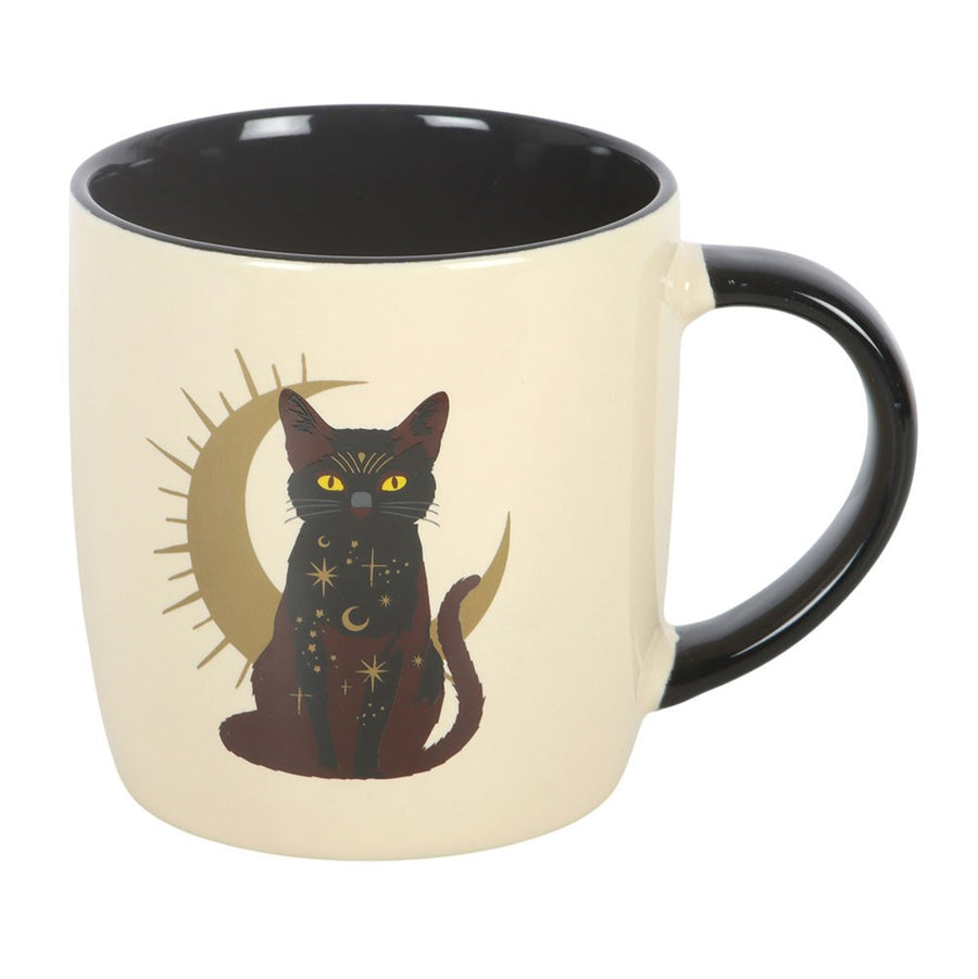 `Sitting Magick Black Cat Mug front view, cream ceramic with gold crescent moon and mystical black cat with yellow eyes, black handle