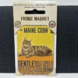A packaged magnet featuring a Maine Coon cat on a yellow background. The sign reads 'MAINE COON' and includes humorous text about the cat chasing objects.