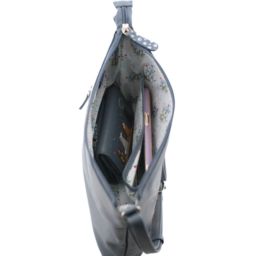Grey handbag with floral interior, containing a phone and purse, on a white background.