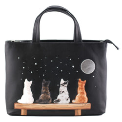 Black leather grab handbag featuring four applique cats on a bench under a moonlit starry sky