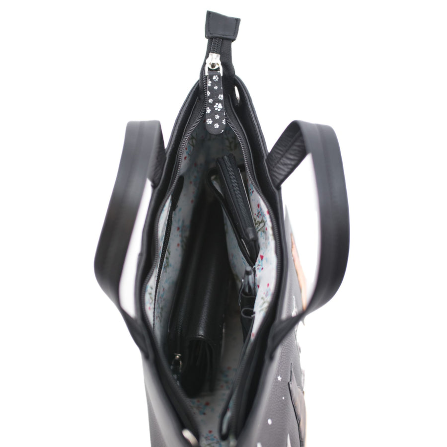 Black handbag with floral interior lining on a white background