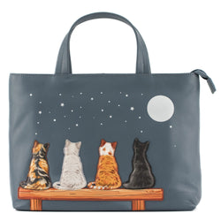 Denim blue leather grab handbag with strap featuring four applique cats on a bench under a moonlit starry sky