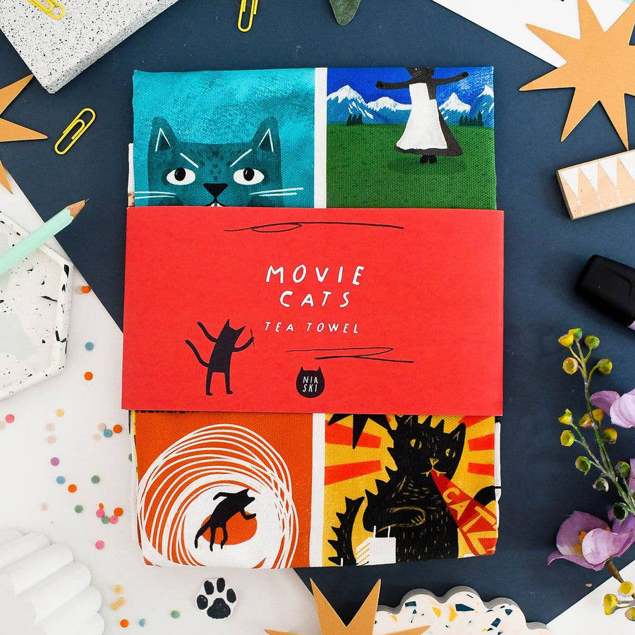 A flat-lay of four colourful movie-themed cat designs