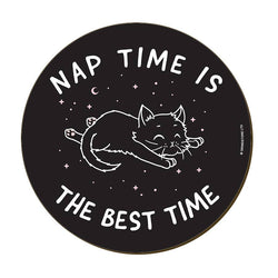 A round black coaster with a white line-art illustration of a sleeping cat, stars, and crescent moon, surrounded by the text 'NAP TIME IS THE BEST TIME'.