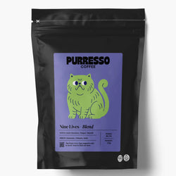 A black stand-up coffee bag with a lavender label featuring a green cartoon cat and the text 'PURRESSO COFFEE' and 'Nine Lives - Blend'
