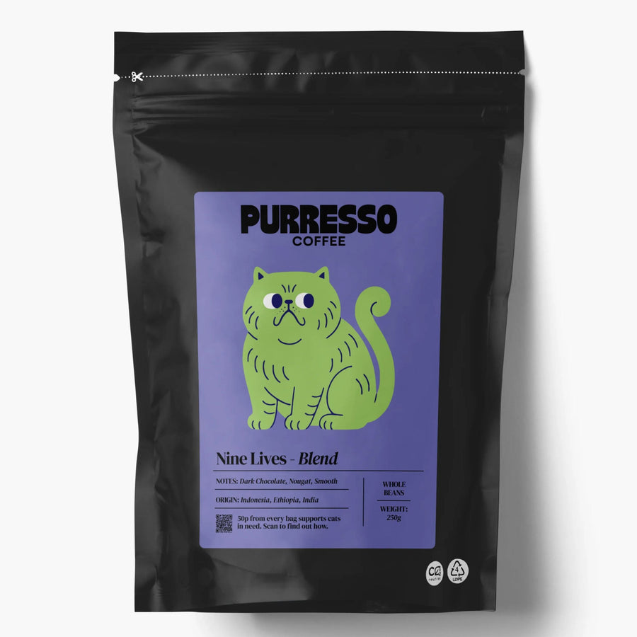 A black stand-up coffee bag with a lavender label featuring a green cartoon cat and the text 'PURRESSO COFFEE' and 'Nine Lives - Blend'