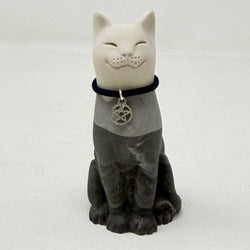 A lucky cat resin figurine, with white head and a dark grey body, wearing a black collar with a silver pentagram charm