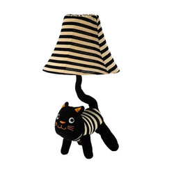 Black and white striped cat with a lampshade on a white background