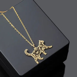 A gold-colored geometric pendant in the shape of a walking cat, displayed on a black stand with a chain.