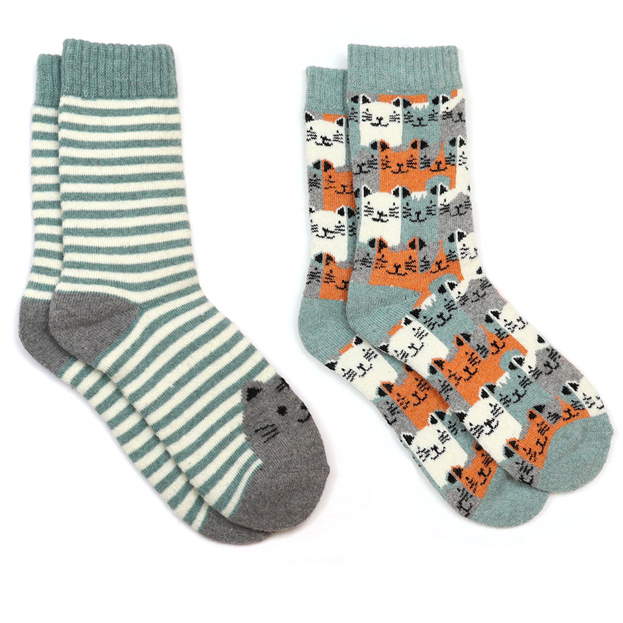 Two pairs of cat design socks with different patterns on a white and mint green background