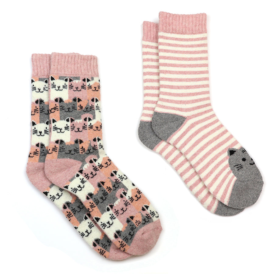 Two pairs of socks with cat patterns on a pink and white background