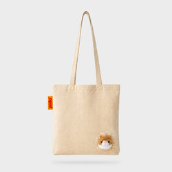 A beige canvas tote bag with two shoulder straps, featuring a small Ginger Cat face near the bottom right corner and a small orange brand tag on the left side