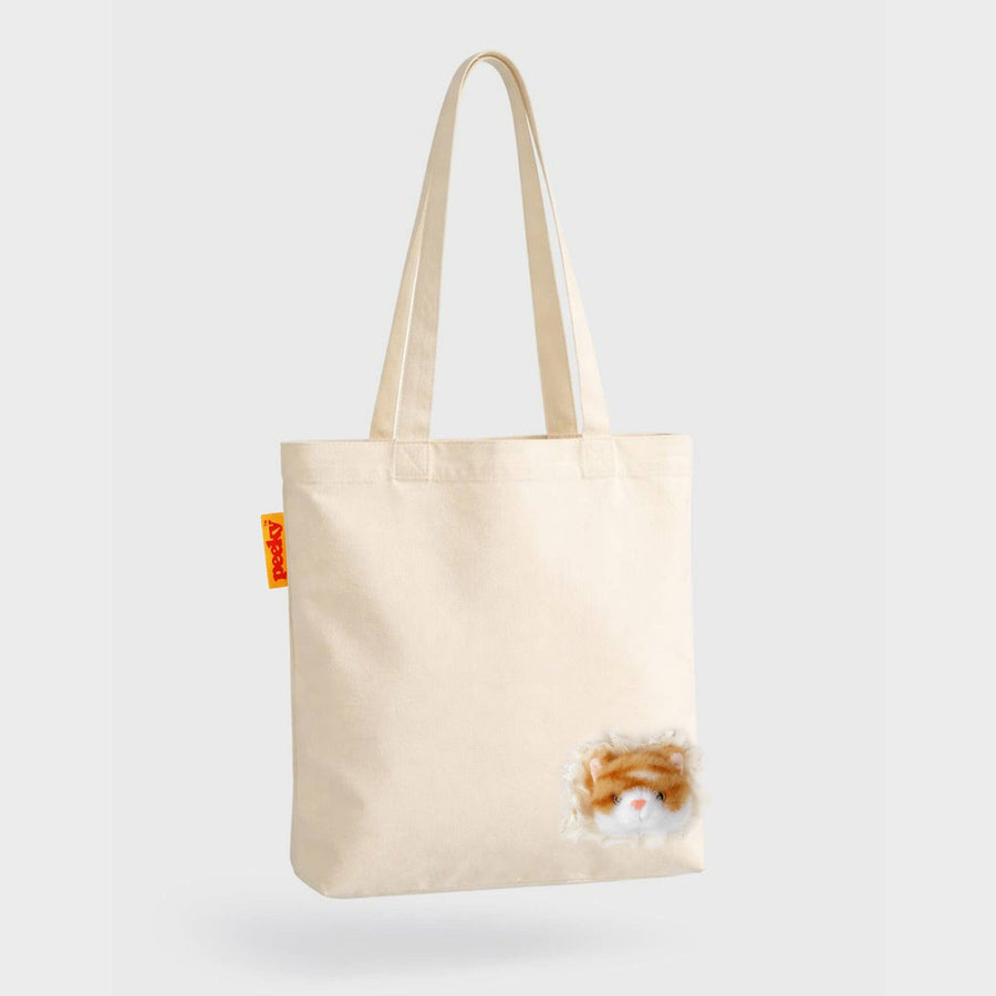 Beige tote bag with a small cat design on a white background