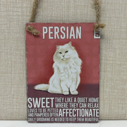 A rectangular hanging sign, featuring a photo of a fluffy white Persian cat on a muted red background with white text that reads 'PERSIAN' and additional cat-care wording.