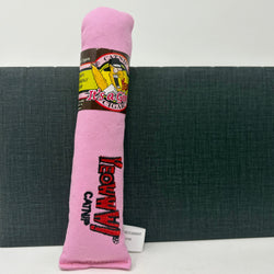 A pink fabric cigar cat toy shaped like a rolled-up cigarette with a paper band around the middle, standing upright 