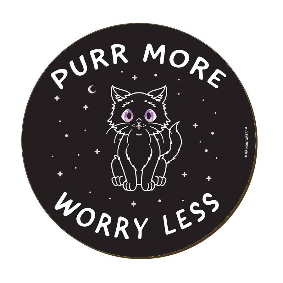 A round black coaster featuring a white line-art illustration of a cat with purple eyes, surrounded by stars and the text 'PURR MORE WORRY LESS'.