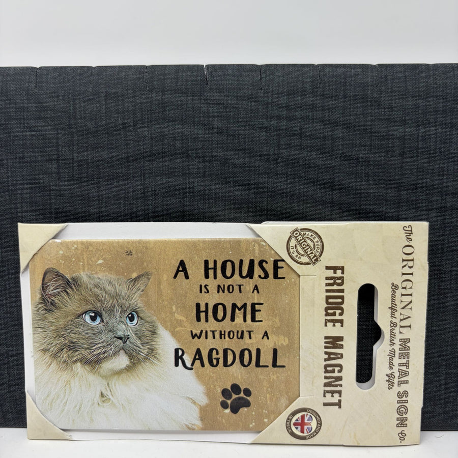 A packaged fridge magnet featuring a fluffy cat photo and the text 'A HOUSE IS NOT A HOME WITHOUT A RAGDOLL.' 