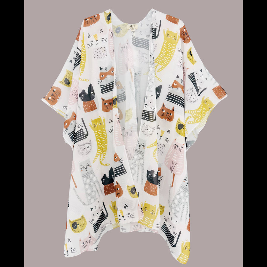 A white open-front kimono cardigan featuring a playful all-over print of cartoon cats in yellow, orange, black, and grey