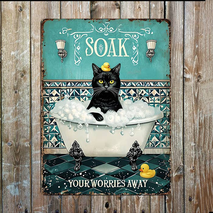 Decorative sign with a black cat in a bathtub and text 'Soak Your Worries Away'