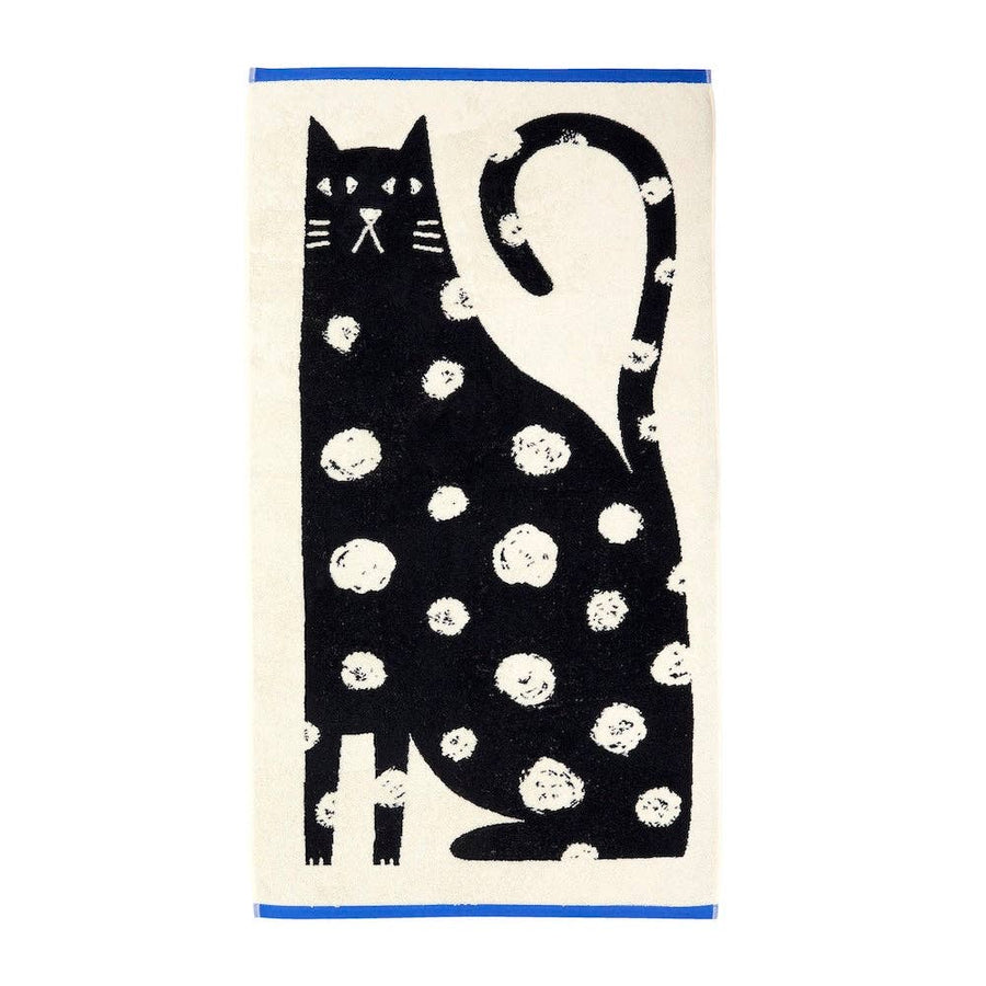 Towel with a white spotted black cat design on a white background