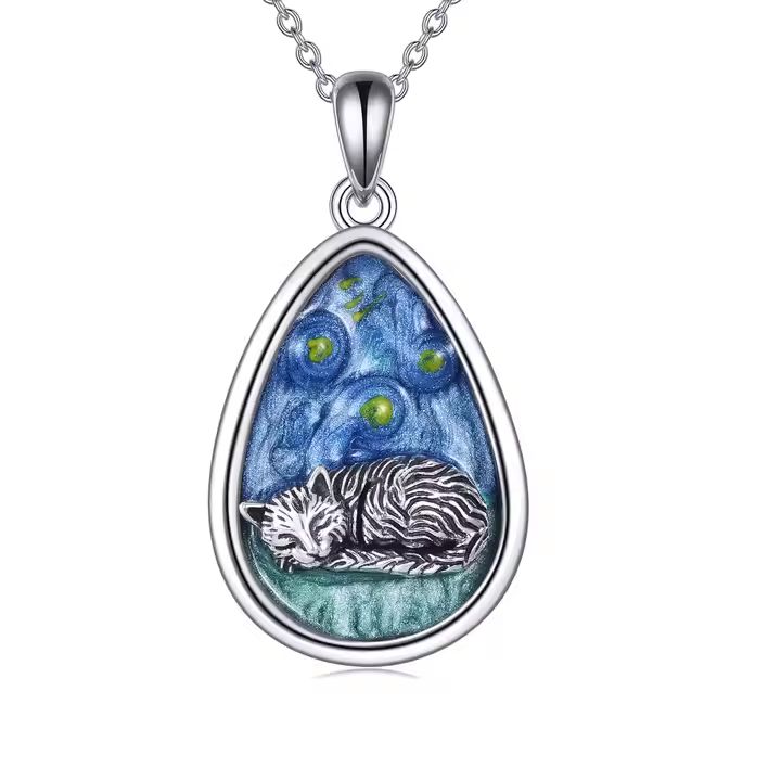 A silver cat pendant with a teardrop shape, featuring a cat design against a starry night background