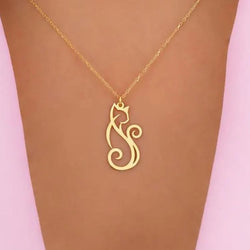 A gold necklace with a stylised cat-shaped pendant, displayed on a lady's chest