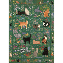 Patterned fabric with cats and flowers on a green background