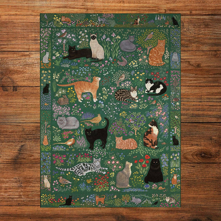 Decorative Jigsaw with cats and nature design on a wooden floor