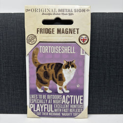 A packaged metal fridge magnet featuring a vintage-style illustration of a tortoiseshell cat on a purple background with the text 'TORTOISESHELL'.