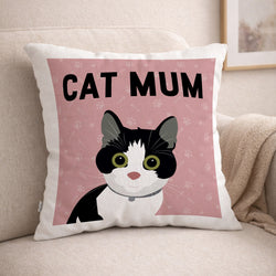 Decorative cushion with a black and white tuxedo cat illustration and 'CAT MUM' text on a pink background, placed on a beige couch.