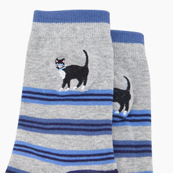Grey socks with blue stripes and black cat design on a white background