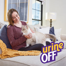 Lady on sofa with her indoor cat. Everything looks clean and bright