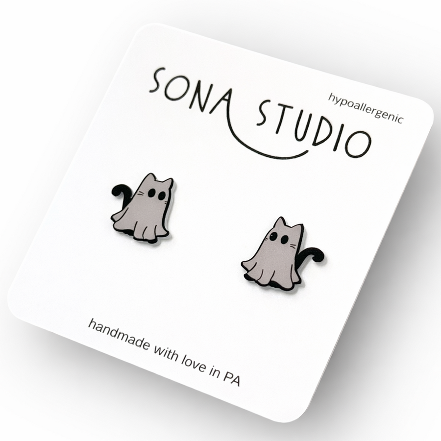 Cat-shaped earrings on a Sona Studio card with 'hypoallergenic' text.