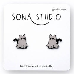 Cat-shaped earrings on a white card with 'Sona Studio' branding.