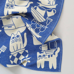 Blue fabric with white cat illustrations on a white background