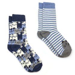 Two pairs of socks on a plain white background: one pair is navy blue with a repeating cat face pattern and the other has light blue and white stripes with a grey cat face on the heel.