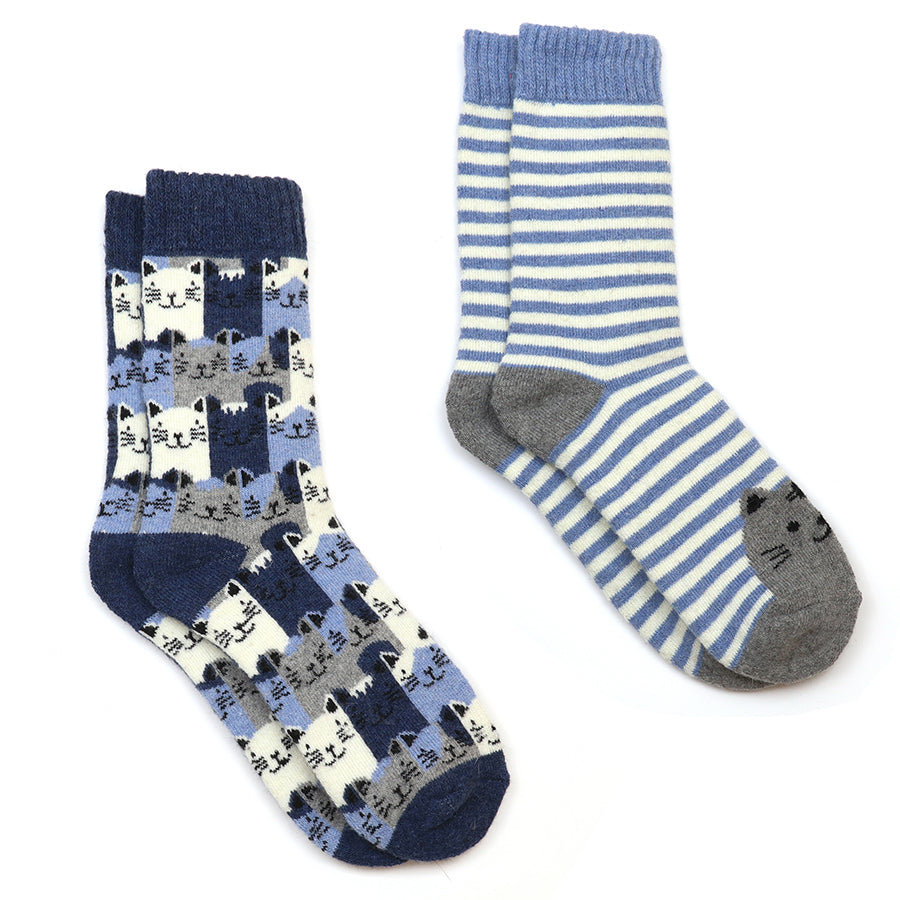 Two pairs of socks on a plain white background: one pair is navy blue with a repeating cat face pattern and the other has light blue and white stripes with a grey cat face on the heel.