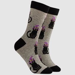 A pair of crew socks in heather grey featuring a repeating pattern of black cats wearing purple witch hats