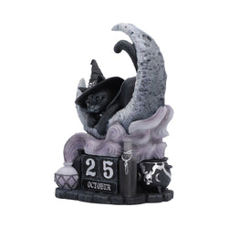Decorative figurine of a cat in a witch hat on a moon with '25 October' text. The whole forming a perpetual calendar - side view