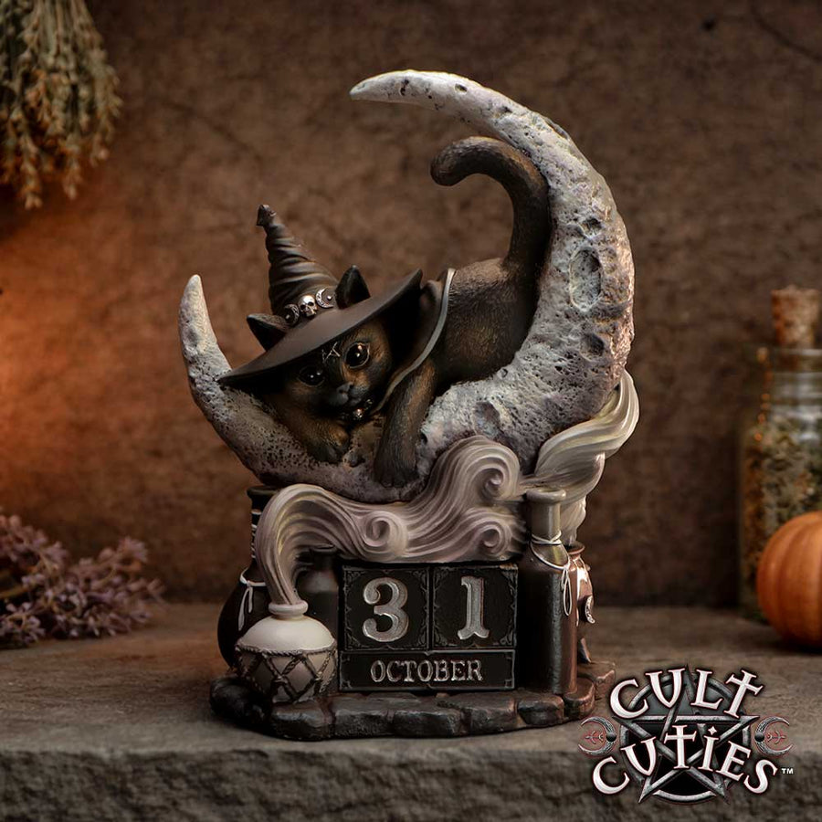 Decorative figurine of a cat in a witch hat on a moon with '31 October' text, branded 'Cult Cuties'. The whole forming a perpetual calendar.
