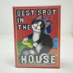 A square red box with a cartoon cat illustration and the text 'BEST SPOT IN THE HOUSE' on the front, photographed against a plain light background.