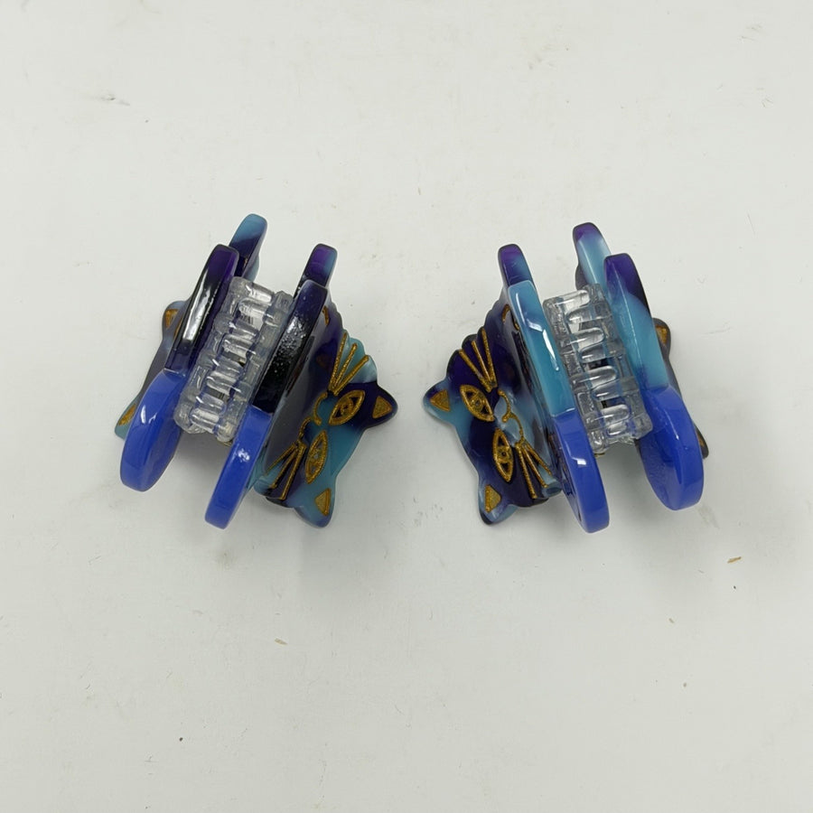 Pair of blue / purple mini hair claws showing the teeth