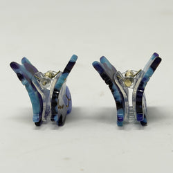 Pair of butterfly-shaped cat hair claws, side view
