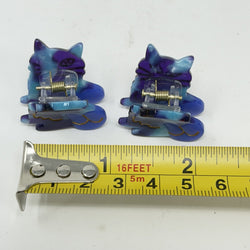 Pair of blue / purple cat shaped hair claws with measure to show size