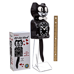 Black cat-shaped kit cat clock with packaging and a ruler for scale on a white background