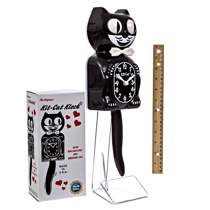 Black cat-shaped kit cat clock with packaging and a ruler for scale on a white background